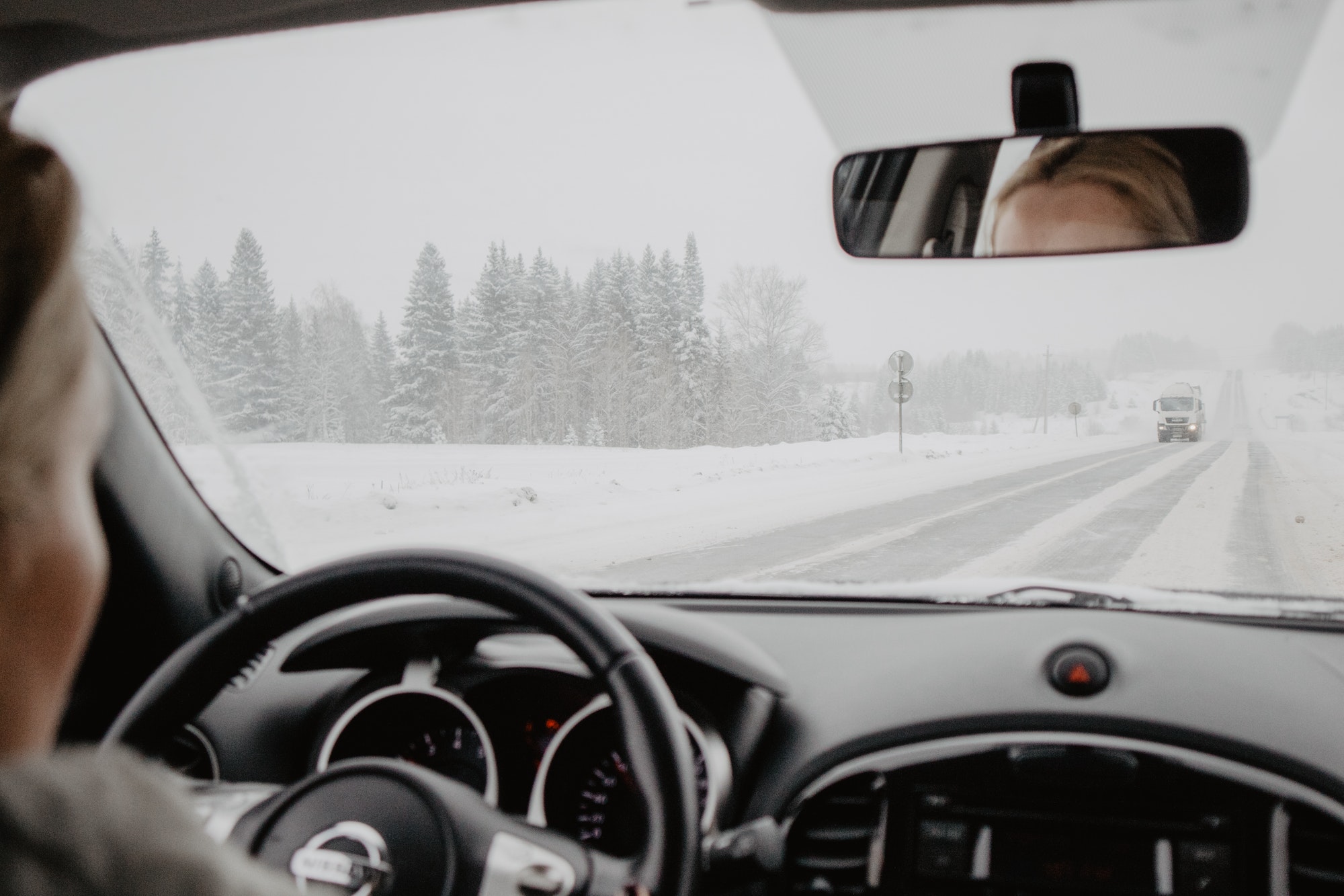 Woman driving a car on a winter day